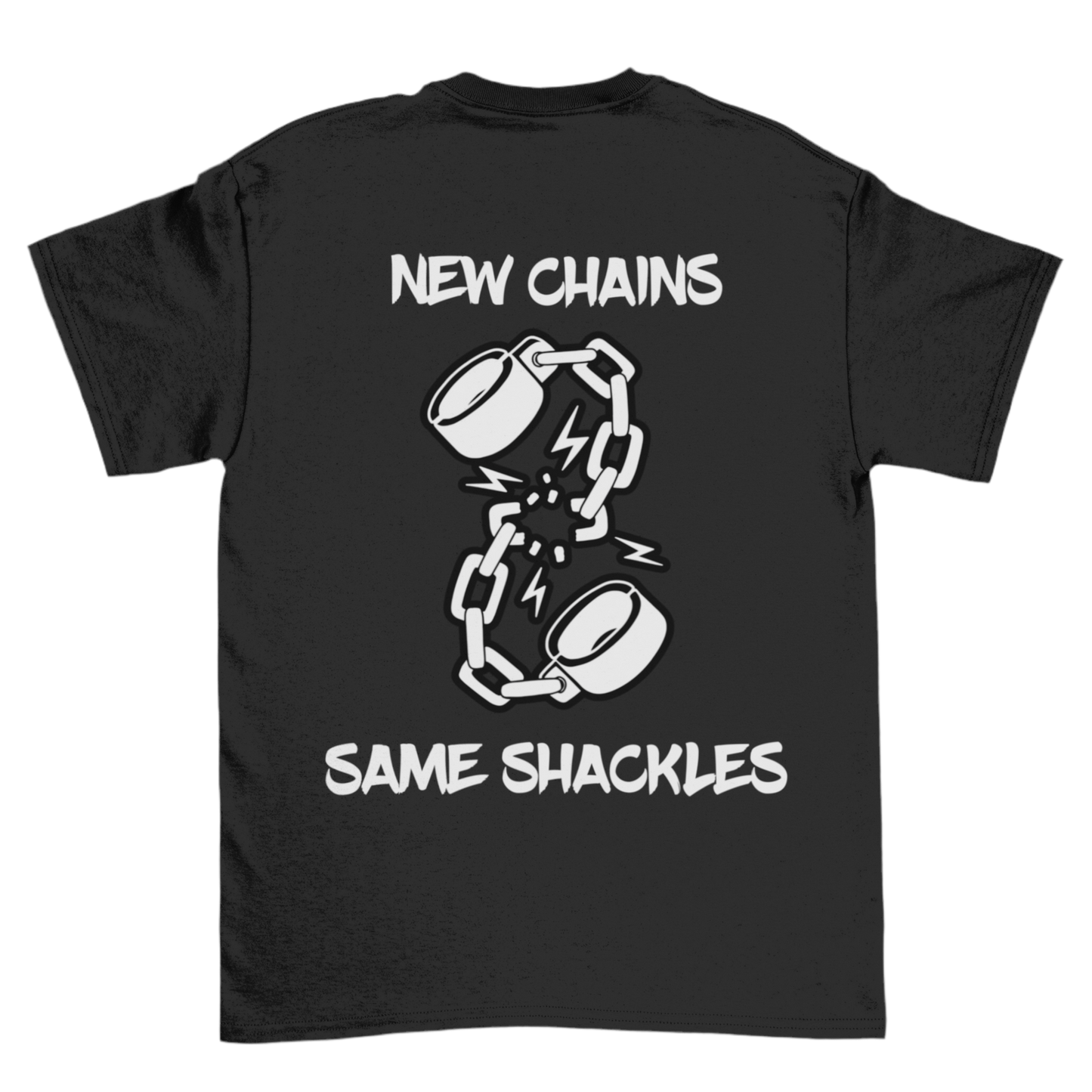 The image is of a black T-shirt featuring a design on the back. The design includes an illustration of broken shackles with lightning bolts around the break, symbolizing a sense of breaking free or resistance. The text above and below the illustration reads: “New Chains, Same Shackles”