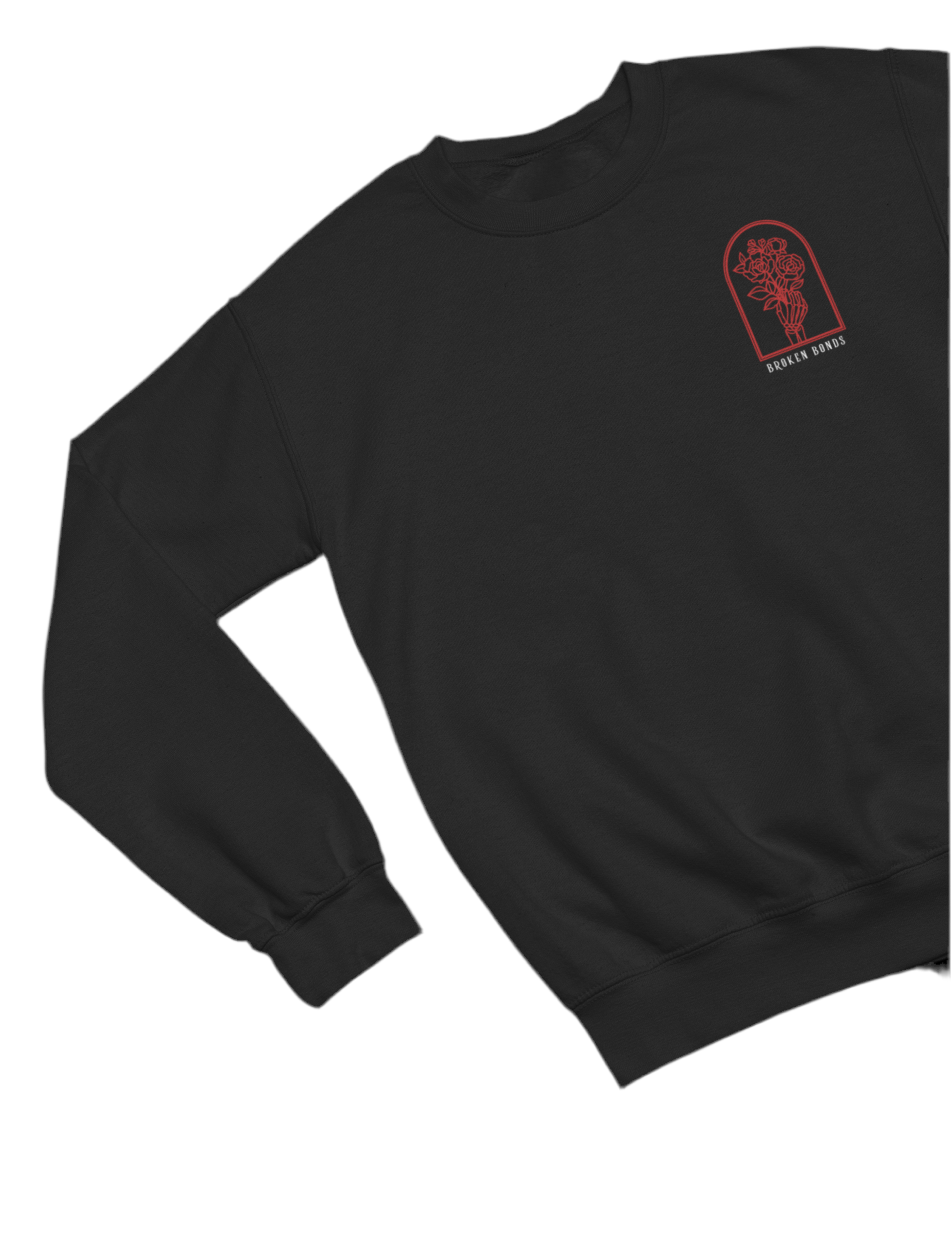 This black sweatshirt features a minimalist yet striking front design. The small chest graphic consists of a skeletal hand holding a bouquet of roses, enclosed within an arched frame. Below the artwork, the words “BROKEN BONDS” are written in a simple yet bold font. 