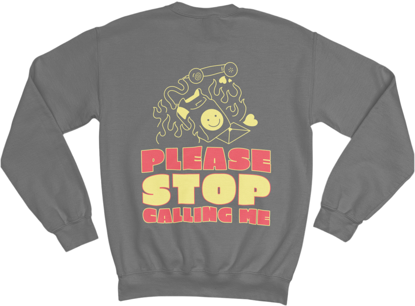 The image shows a grey sweatshirt with a graphic design on the back. The design features a burning old-school phone with a smiley face on its screen, a detached phone receiver, and small heart shapes around it. Below the illustration, bold, retro-style text in red and yellow reads: “PLEASE STOP CALLING ME”