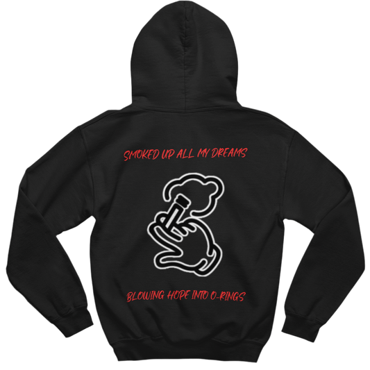 This black hoodie in the image has a white outline graphic of a hand holding a smoking object, exhaling a cloud of smoke. The text on the shirt is red and reads: “SMOKED UP ALL MY DREAMS” (at the top)
“BLOWING HOPE INTO O-RINGS” (at the bottom)  