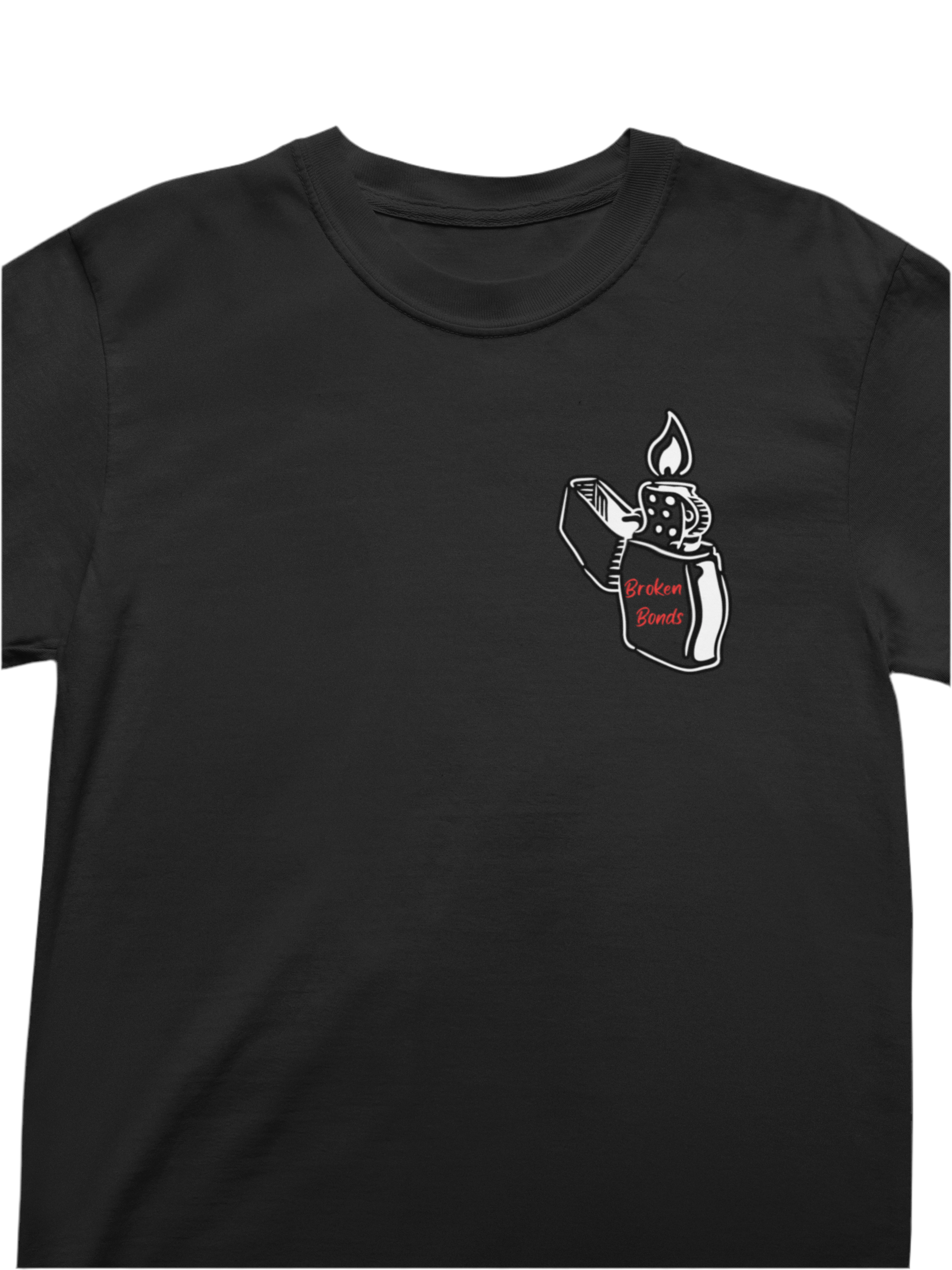 This black T-shirt has a small graphic on the left chest area. The design features a white-outlined illustration of a flip-top lighter with a flame. On the lighter, the words “Broken Bonds” are written in red.