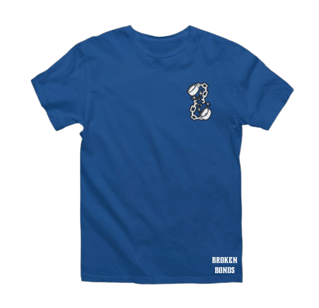 This image shows a blue T-shirt with a minimalist design. The front of the shirt features a small graphic on the left chest area, depicting broken shackles with lightning bolts around the break, symbolizing breaking free. Additionally, the bottom right corner of the shirt has the text “BROKEN BONDS” in bold, white capital letters.